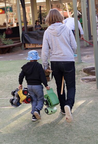 Back of educator and child walking away