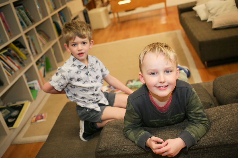 Boys in book corner looking at camera