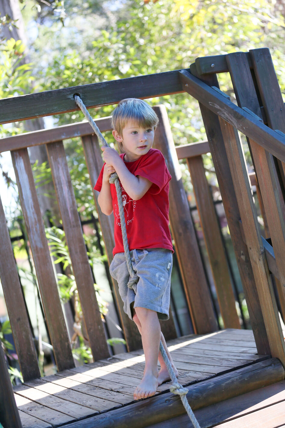 Boy red shirt on rope