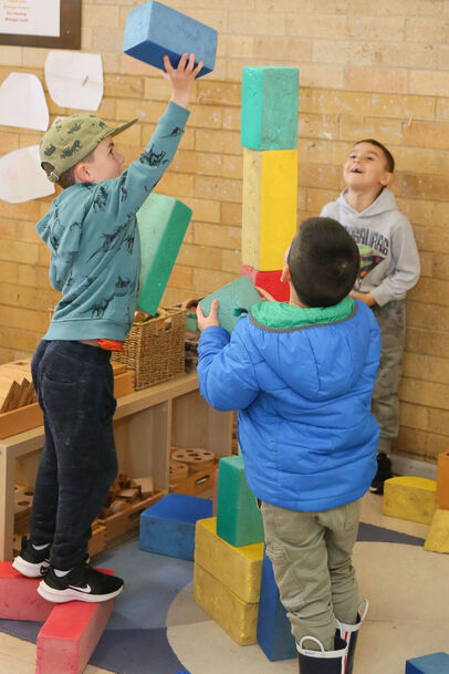 Boys building a block tower