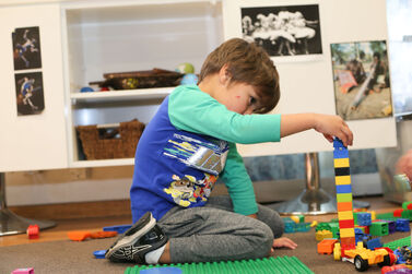 Boy stacking duplo