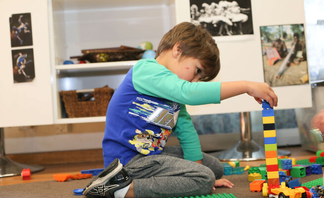 Boy stacking duplo