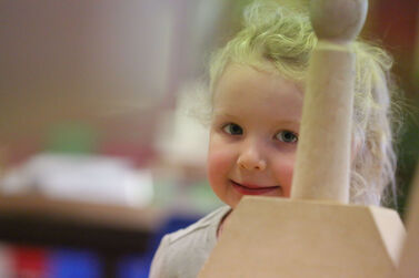 Close up of girl through block tower