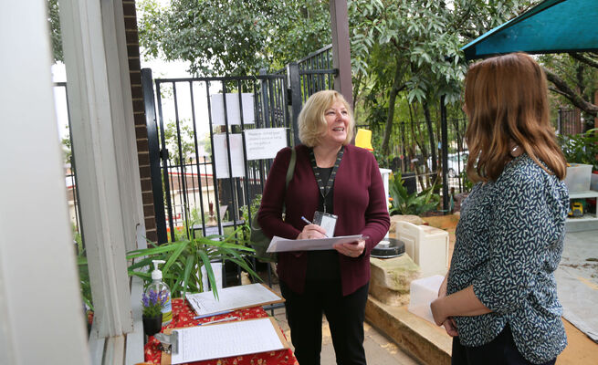 Heather and Emma talking at entry