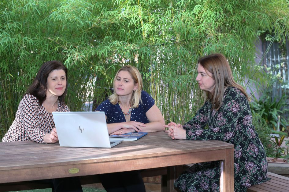 Consultants outside at table with laptop