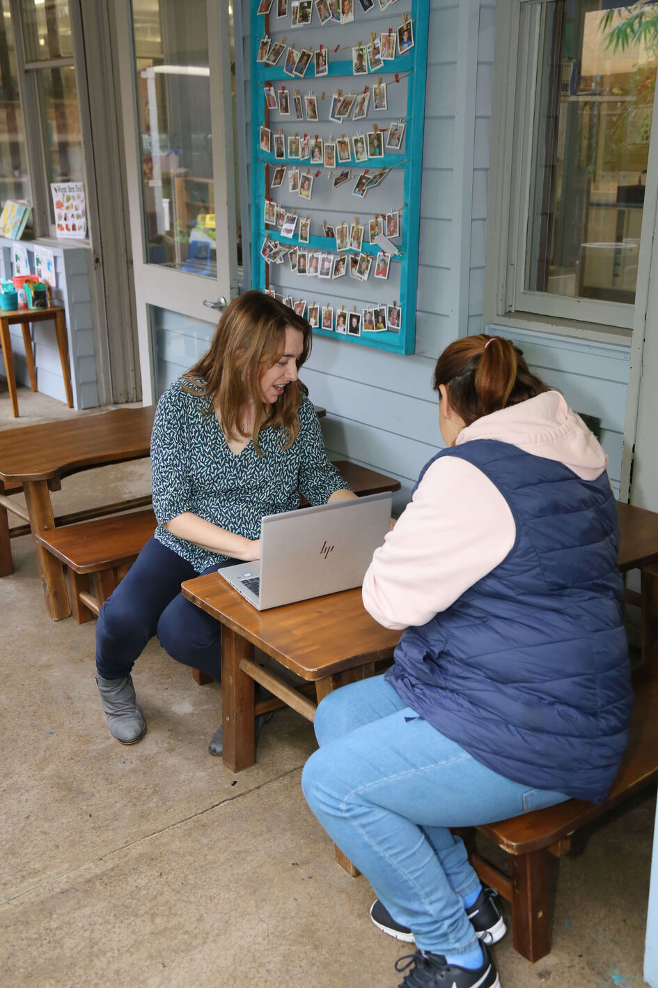 Emma and educator at child sized table with laptop