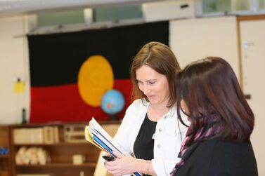 Mika and educator with Aboriginal flag