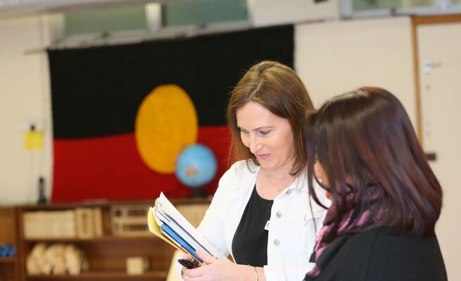 Mika and educator with Aboriginal flag