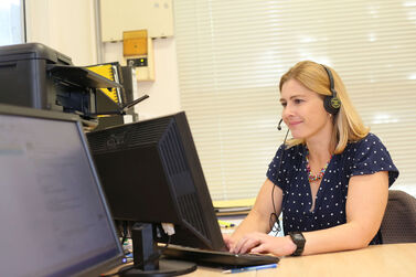 Bel at computer with headphones