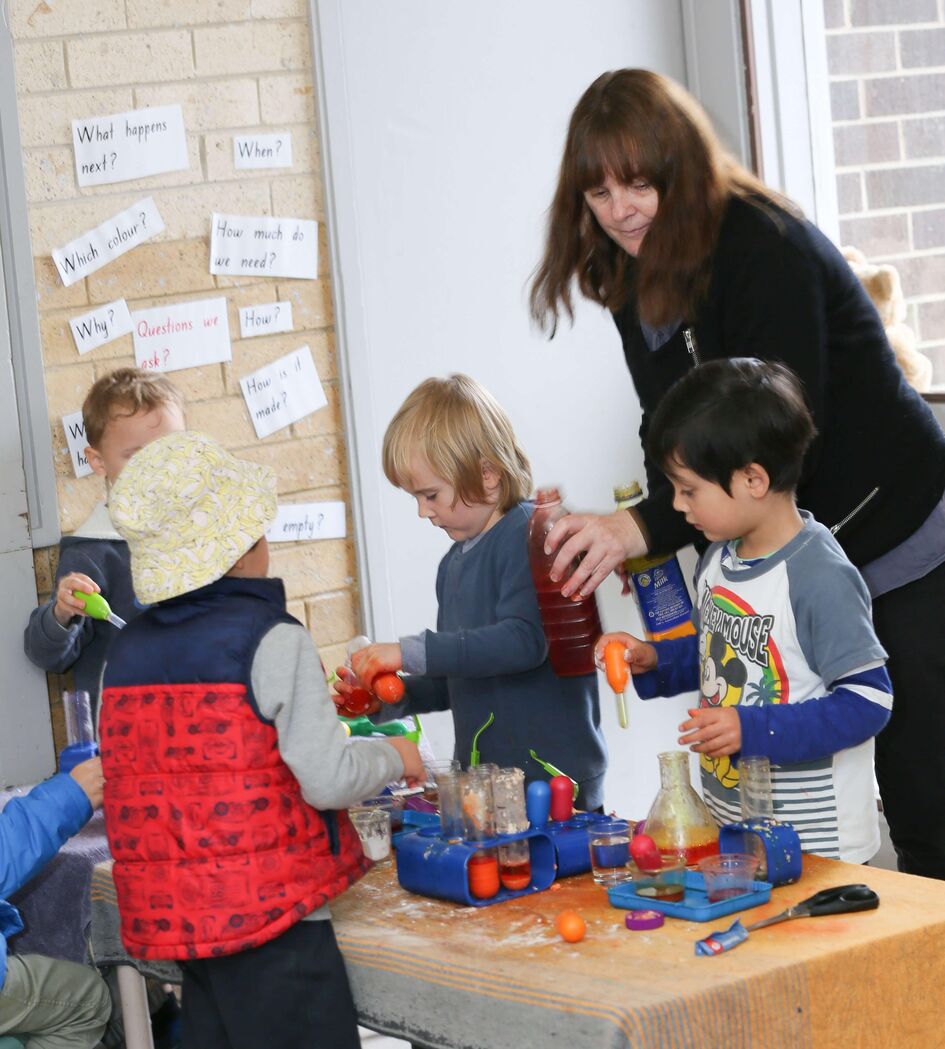 Educator with children at science table