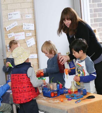 Educator with children at science table