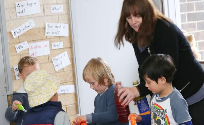 Educator with children at science table