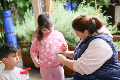 Educator blue top helping child