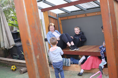 Educator with group both genders daybed outside