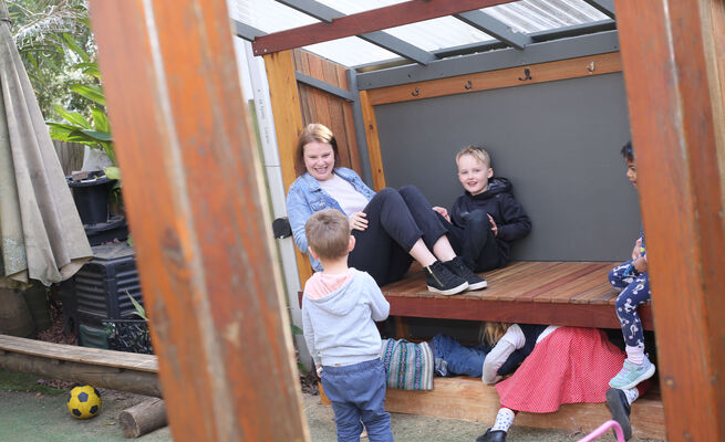 Educator with group both genders daybed outside